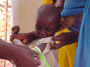 Personal de MSF evalúa el estado nutricional de un niño gracias al brazalete MUAC (que mide el perímetro braquial). Proyecto de Tawila, Darfur. (Foto: MSF).