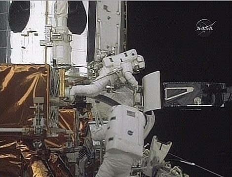 Los astronautas Grunsfeld (arriba) y Feustel (abajo) reparan el Hubble. | NASA