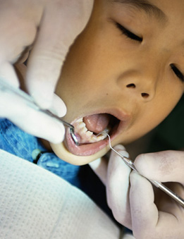 Un dentista examina la boca de un menor. (Foto: El Mundo)